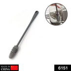 Long-handled kitchen brush effectively cleaning a bottle.