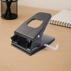 Demonstration of punching tool with ergonomic handle on paper punch