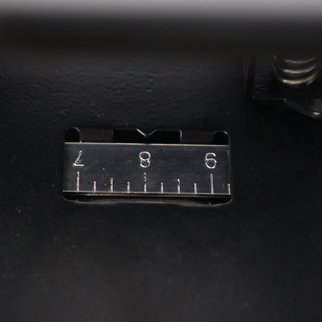 Close-up of hole punch area on metal 2-hole paper punch machine