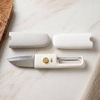 The 2-in-1 kitchen tool, a knife and peeler, displayed neatly on a kitchen counter.