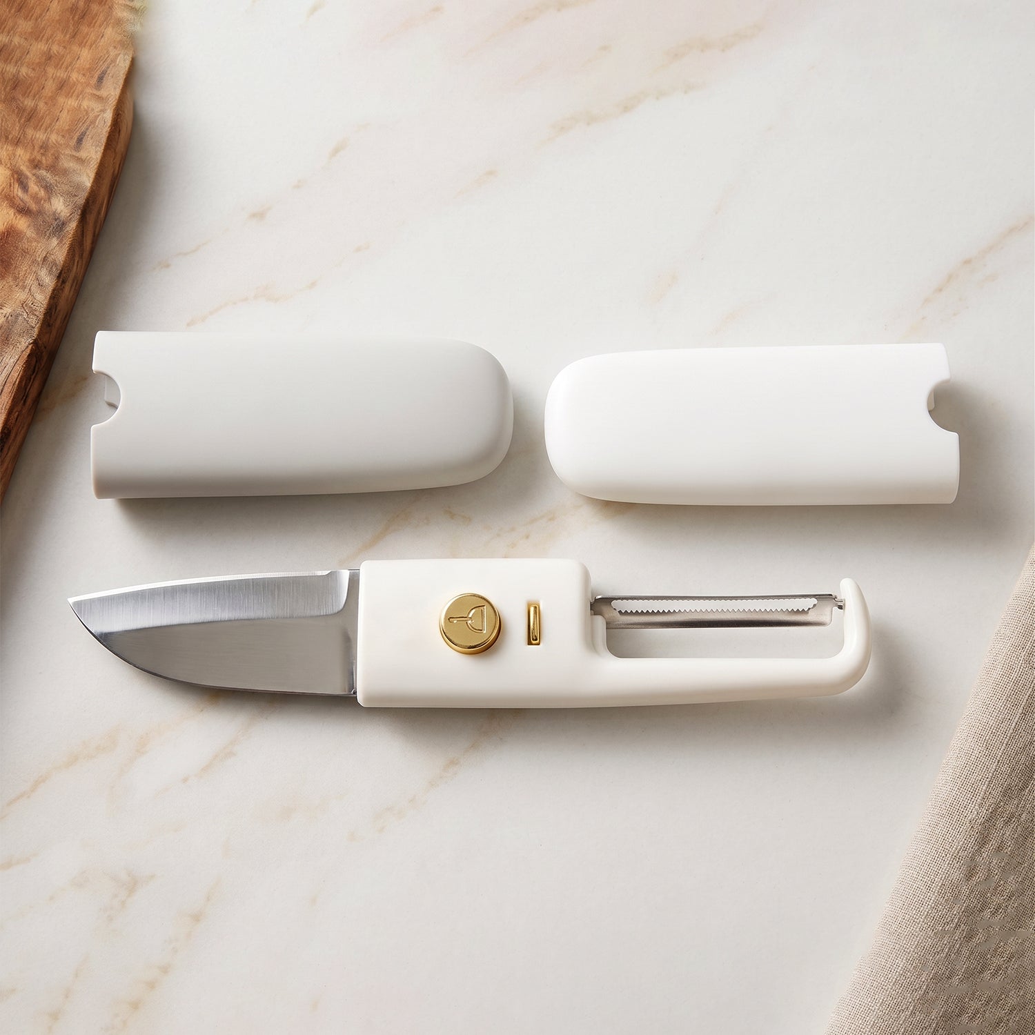 The 2-in-1 kitchen tool, a knife and peeler, displayed neatly on a kitchen counter.