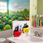 Close-up of the robust suction hook on the back of the ladybug toothbrush holder.