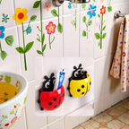 Detailed view of the charming Ladybug toothbrush holder in red and black.