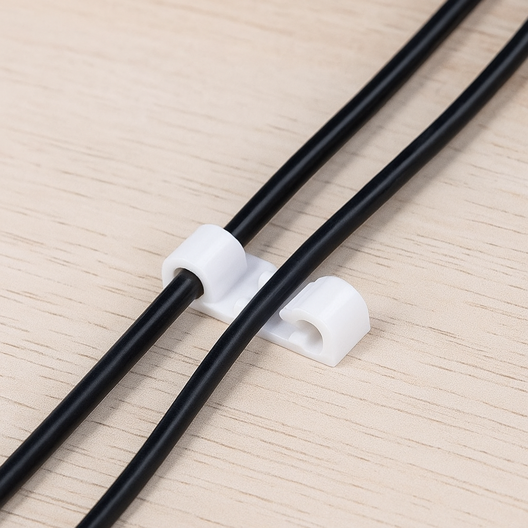 Multiple cable clips securing various power cords to maintain an organised workspace.