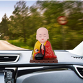 Peaceful Solar Buddha Statue with moving head and hand, ideal for home decor.