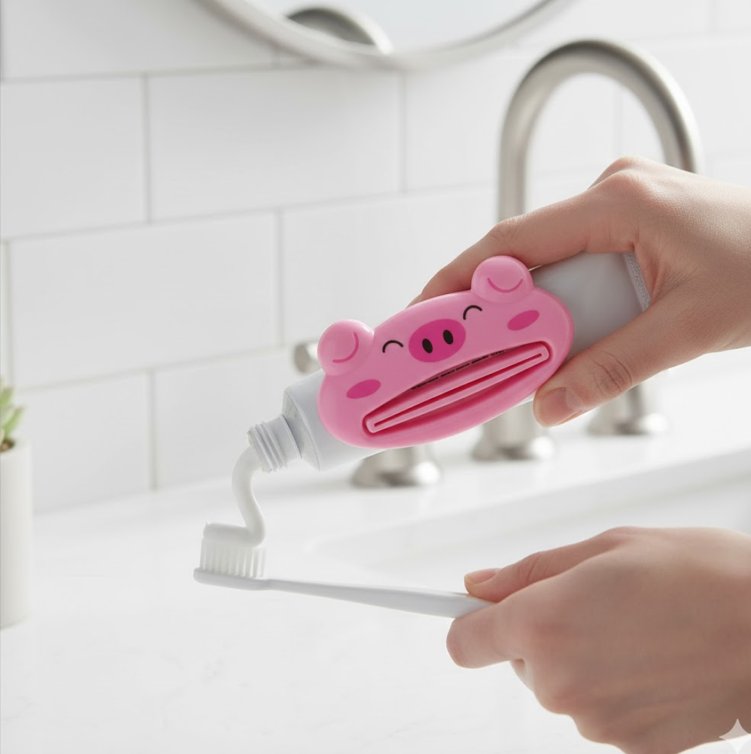 Different angle of animal toothpaste squeezer showcasing its functionality.