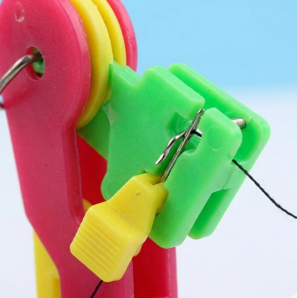 Ergonomic side view of the compact automatic needle threading tool.