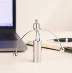Dynamic shot of the steel balance toy's swinging balls, creating a mesmerizing effect.