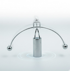 The Newton Cradle's metal balls in mid-swing, illustrating kinetic energy transfer.
