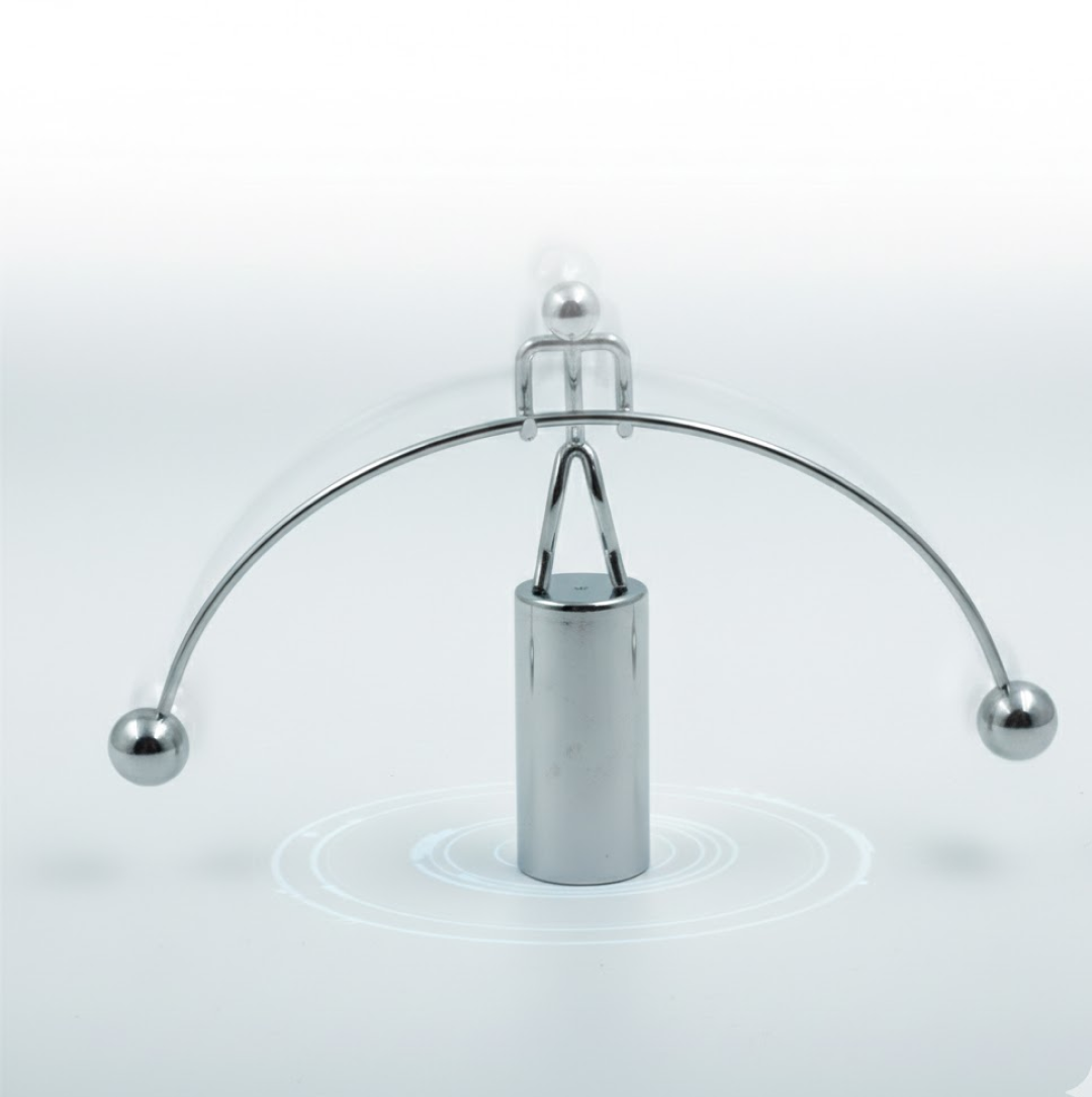 The Newton Cradle's metal balls in mid-swing, illustrating kinetic energy transfer.