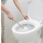 The toilet brush with holder in a clean, minimalist bathroom setting.
