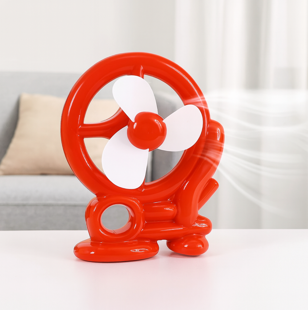 Front view of the quiet red Mini Cooling USB Fan with protective grill.