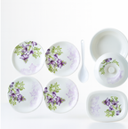 Full view of the 32-piece plastic tableware set, featuring plates, bowls, and serving dishes.