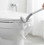 Wall-mounted holder securely storing the golf toilet brush, saving space.