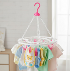 Close-up of the durable plastic clips on the multicolour drying stand.