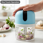 The mini electric garlic chopper in operation, securely chopping ingredients with its lid locked.