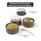 An open Ganesh stainless steel lunch box filled with a delicious Indian meal.