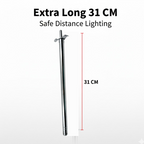 Stainless steel gas lighter igniting a kitchen stove burner.