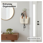 Punch-free sticky hook holding towels in a modern bathroom setting, showcasing its practicality.