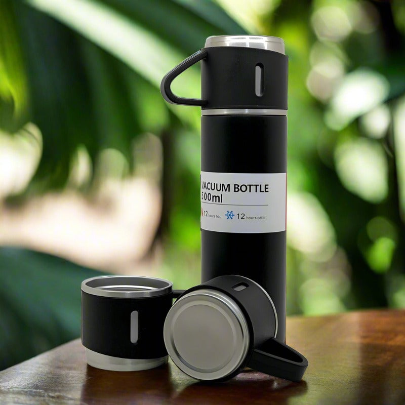Elegant Stainless Steel Vacuum Flask and three durable steel cups for travel.