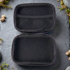 Open empty travel storage case showing interior compartments