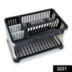 Multi-level kitchen dish rack organizing plates, cups, and cutlery.
