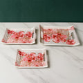 Stacked plastic serving tray set with a vibrant floral print.