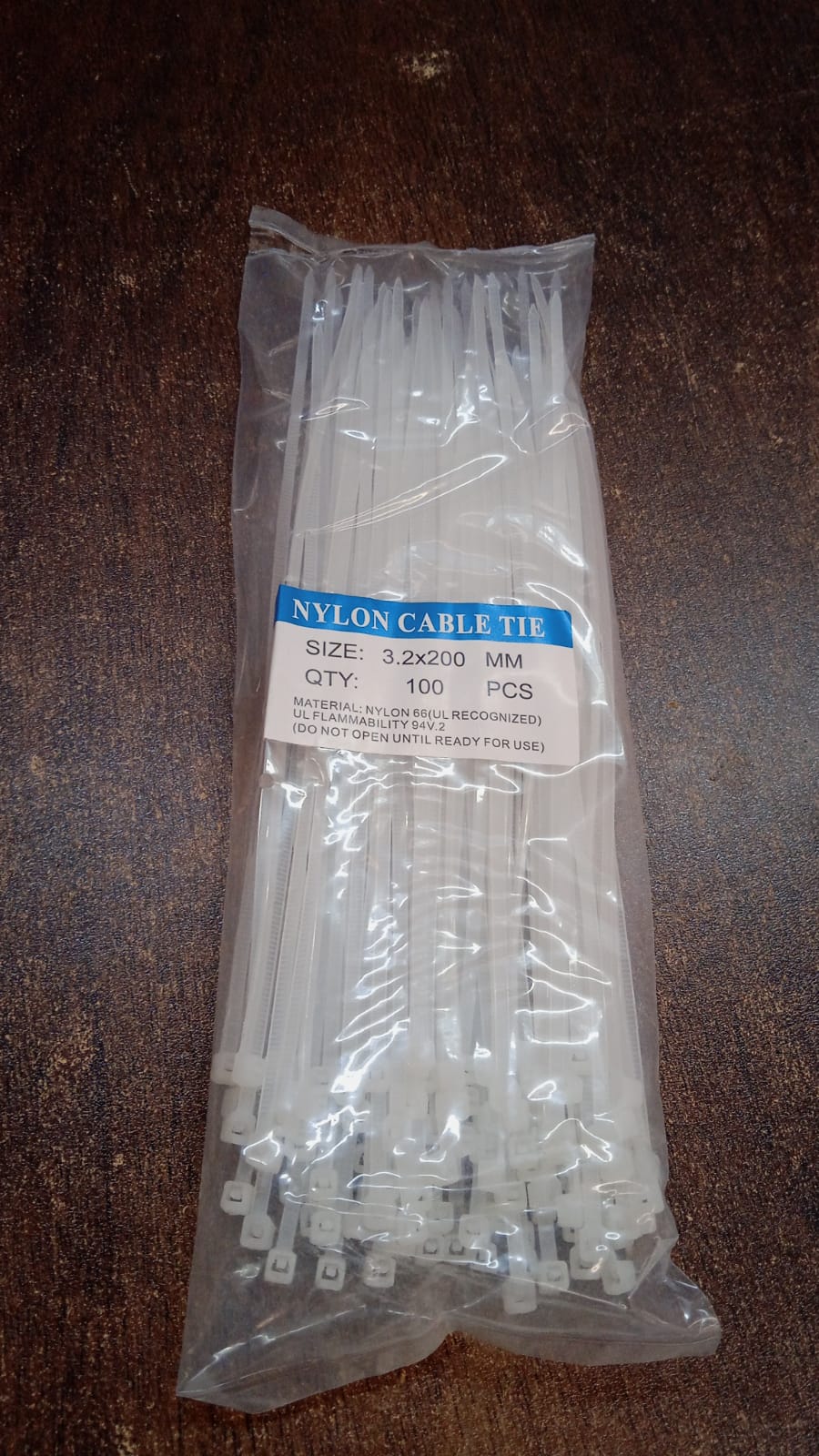 A pile of black nylon cable ties, showcasing their quantity and readiness for use.