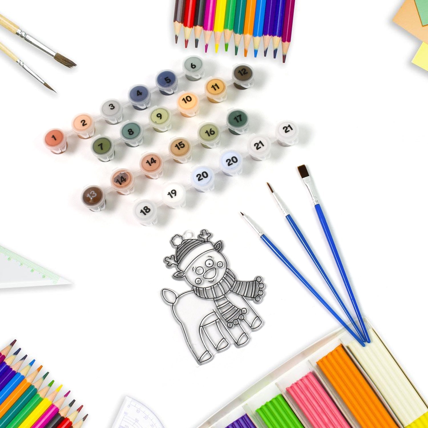 Contents of the Paint by Number Kit laid out, including canvases, color palette, and painting tools.
