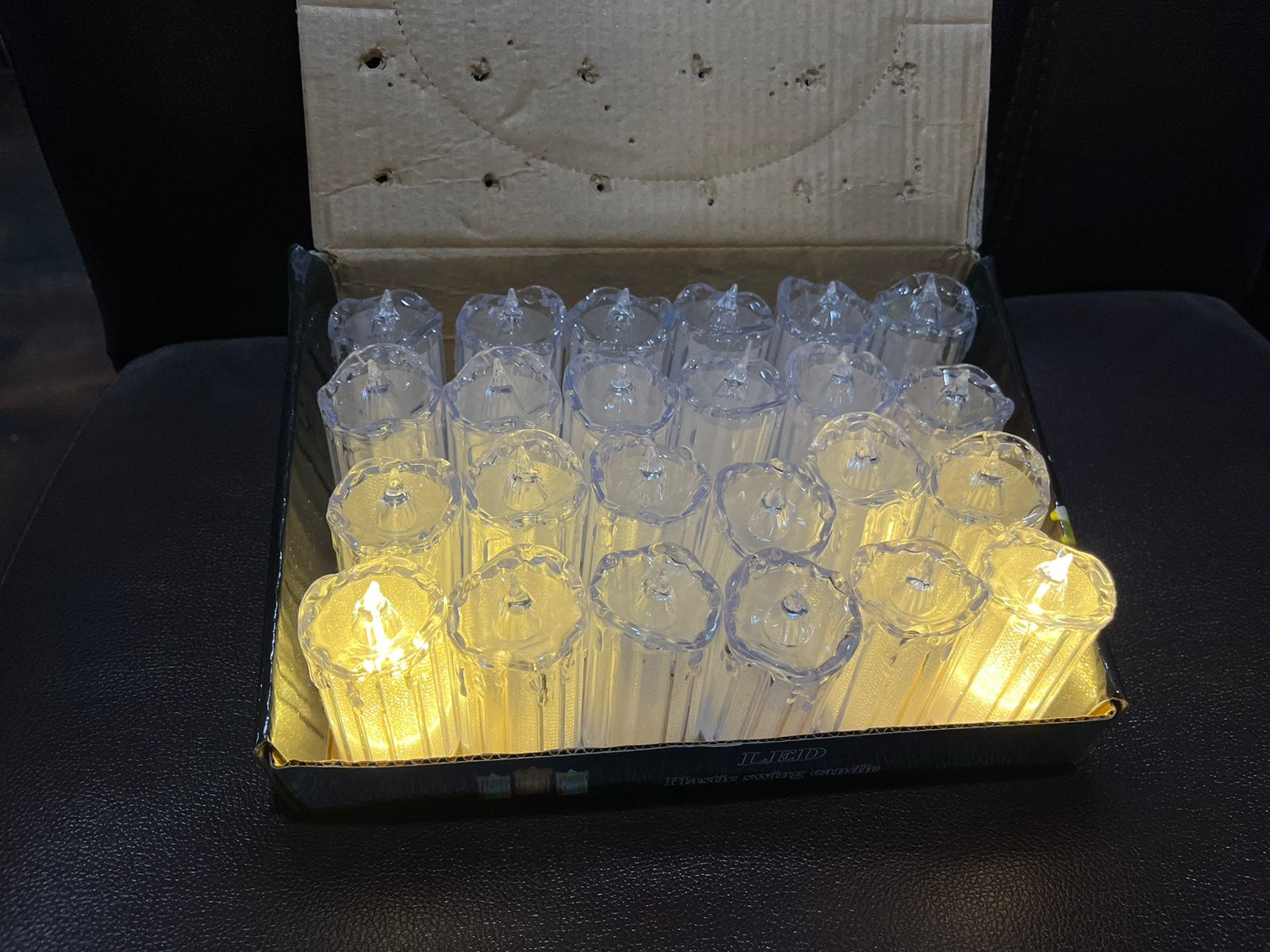 Assortment of glowing LED tea light candles creating a warm ambiance.
