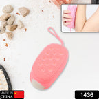 Close-up of the dual-sided body scrubber highlighting its soft silicone texture.