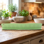 Kitchen sink splash guard installed on a counter, protecting from water.
