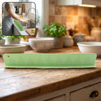 Main view of the flexible kitchen sink splash guard in green.