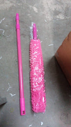 A person effectively cleaning a ceiling fan with the long-handled microfiber duster.