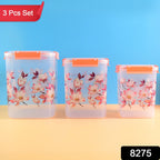 Three floral airtight food storage containers on a kitchen counter.