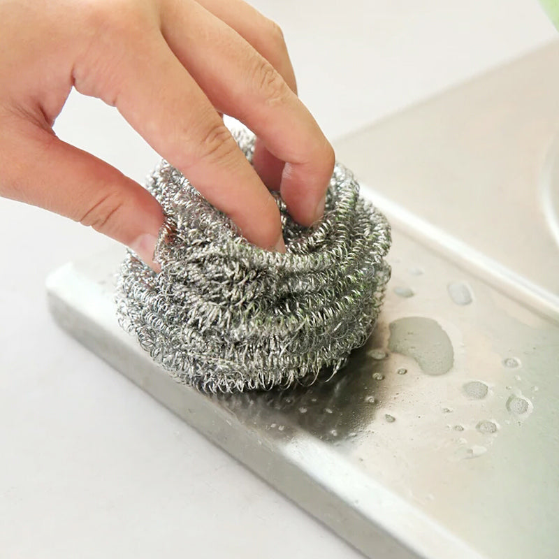 A set of round stainless steel scrubbers, perfect for tackling tough stains on pots and pans.