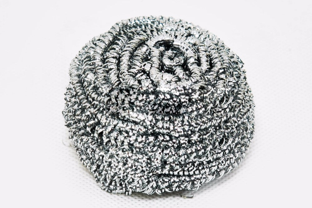 Round stainless steel scrubber showing its intricate wire design for superior scrubbing.