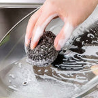 Pack of 12 round stainless steel scrubbers ready for heavy-duty kitchen cleaning.