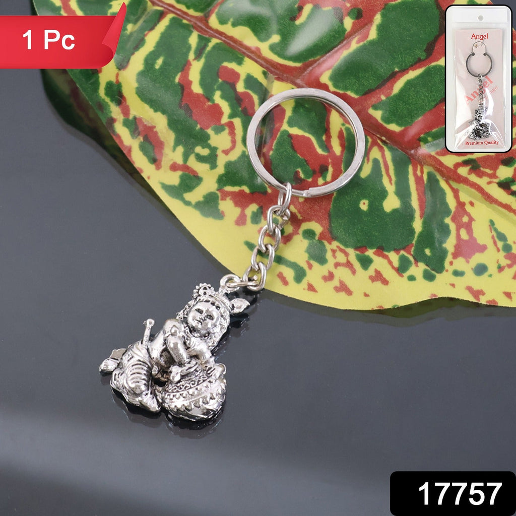 Close-up of Bal Krishna Makhan Chor silver keychain held in hand showing intricate details