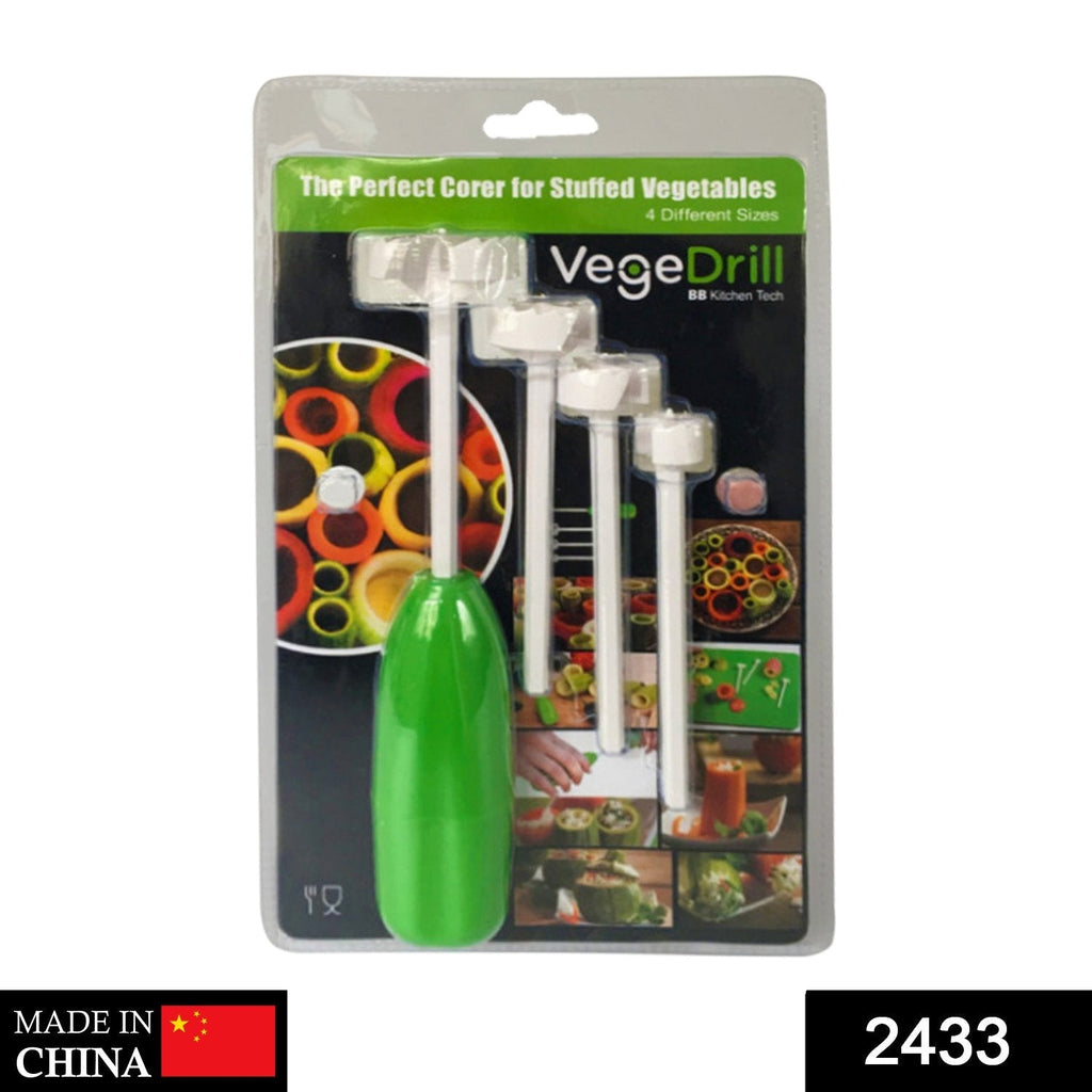 Hand using the vegetable corer tool to hollow out a green vegetable.