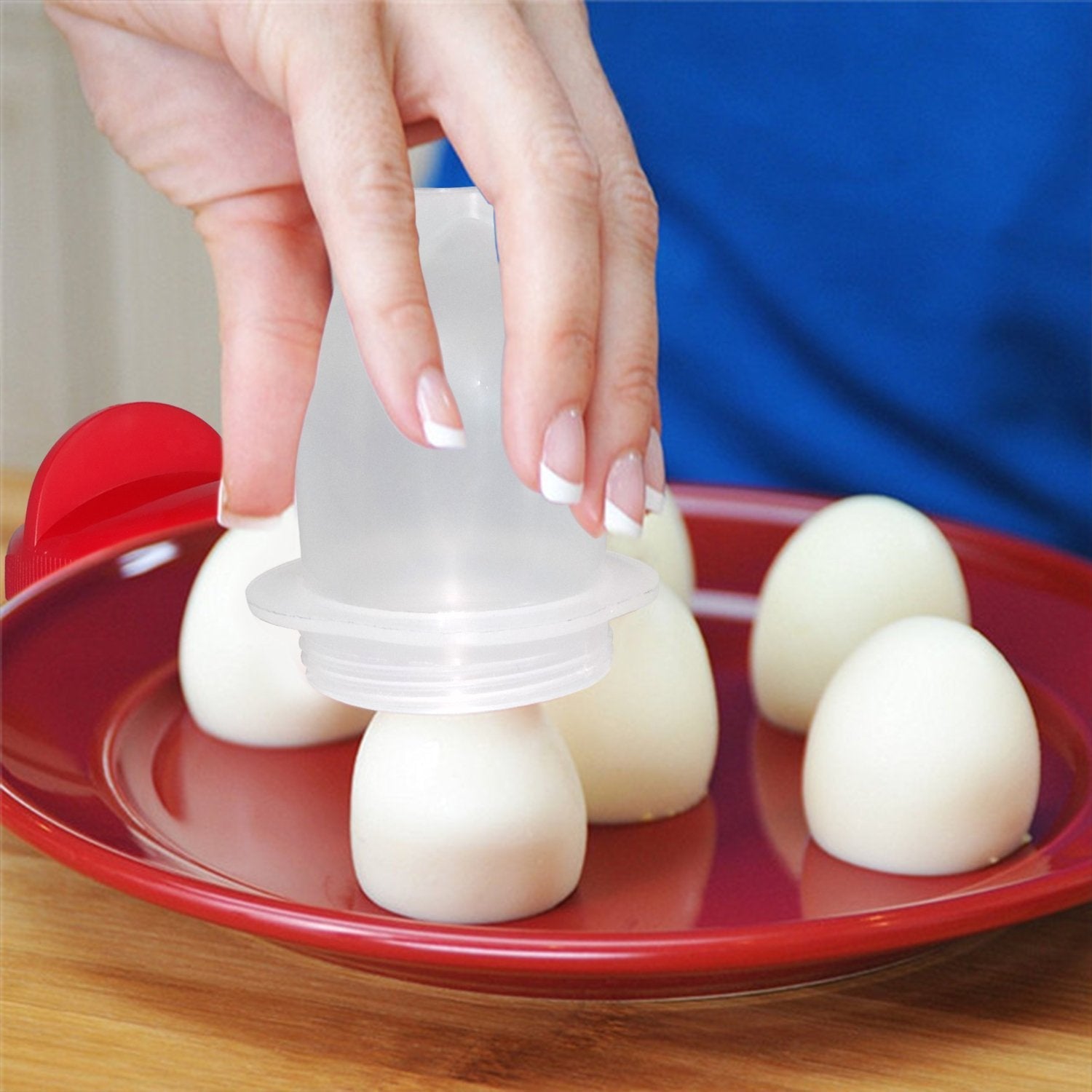 A set of red and white Nonstick Egg Boiler cups displayed, ready for use.