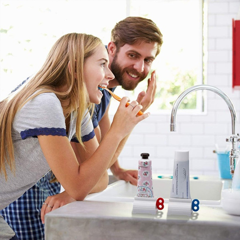 Toothpaste squeezer with a tube inserted, standing neatly on a modern bathroom counter.