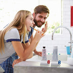 Toothpaste squeezer with a tube inserted, standing neatly on a modern bathroom counter.