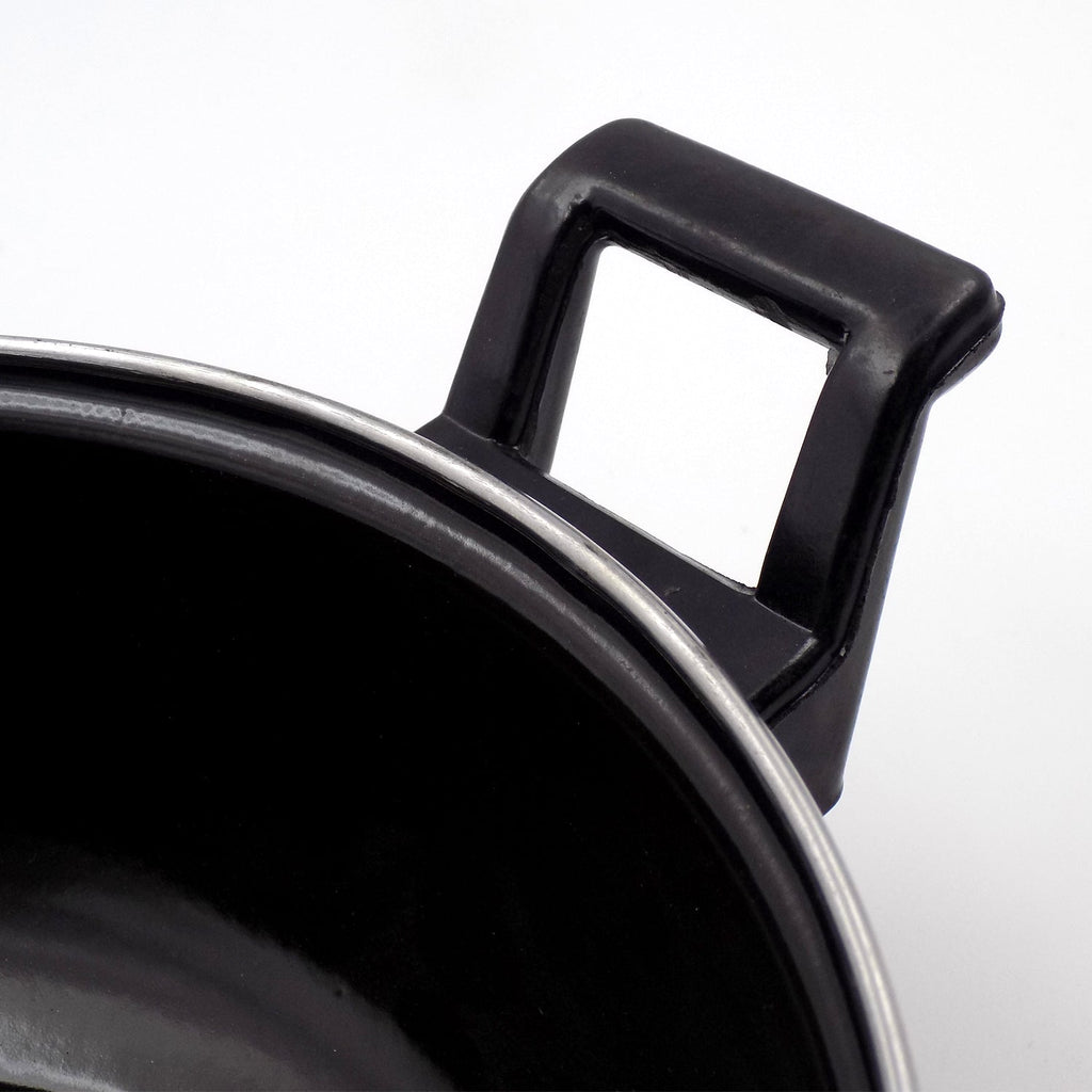 Close-up view of cast iron kadai surface highlighting seasoning