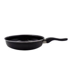 Angled view of the nonstick tadka fry pan, ready for use.