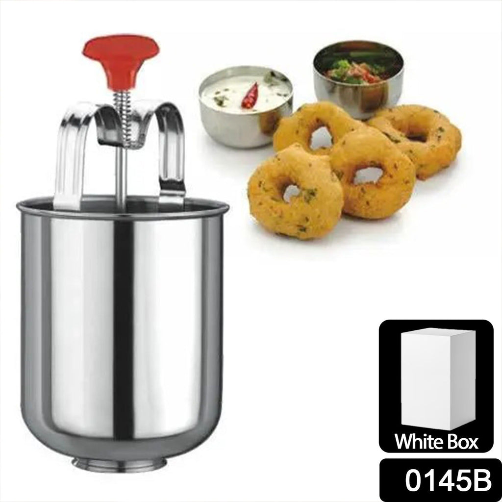 Medu vada batter being dispensed into hot oil using the maker.