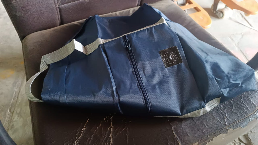Blue travel bag packed with various items, demonstrating its ample storage for a trip.