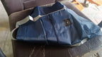 Blue travel bag packed with various items, demonstrating its ample storage for a trip.