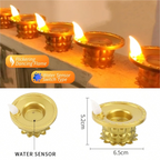Three flameless golden diyas arranged on a dark surface, highlighting their warm glow.