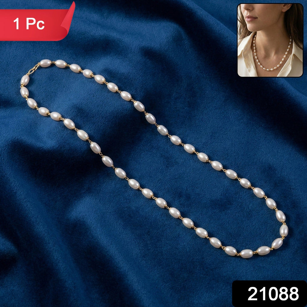 Close-up of gold-tone links on pearl beaded necklace